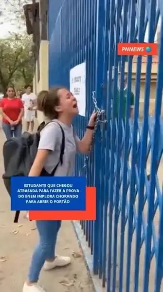 Estudante chorando no portão fechado do ENEM